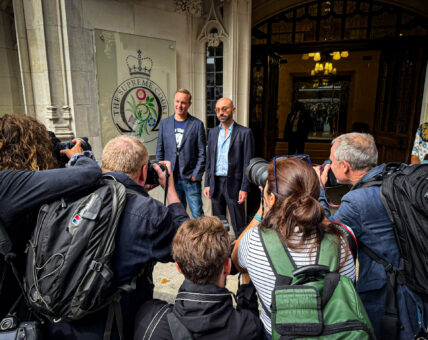 Carlo Palombo and Tom Hayes standing outside the Supreme Court, surrounded by press photographers capturing the moment their convictions were quashed.